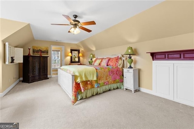 bedroom with light colored carpet, a ceiling fan, vaulted ceiling, and baseboards