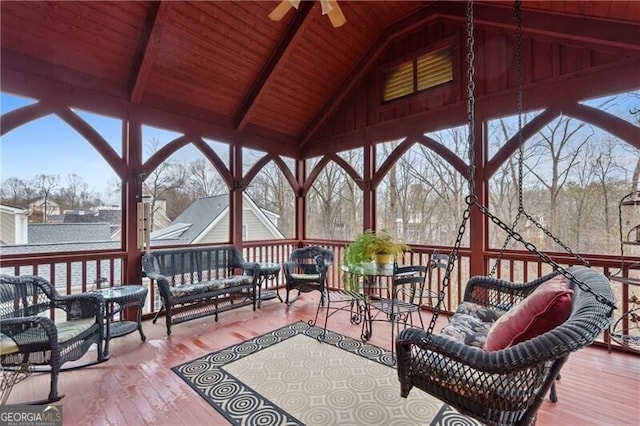 sunroom featuring beamed ceiling and plenty of natural light