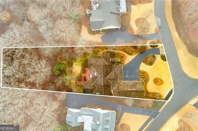traditional-style home with covered porch, aphalt driveway, and a garage