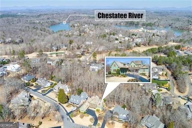 aerial view with a wooded view, golf course view, and a residential view