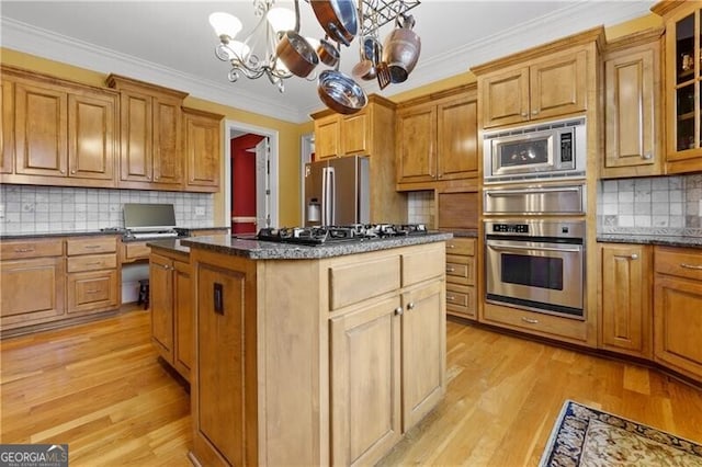 kitchen with stainless steel appliances, open shelves, a warming drawer, brown cabinets, and a sink