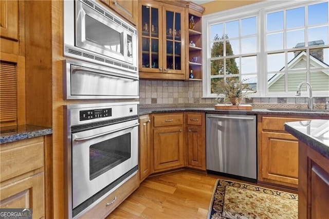 kitchen with decorative backsplash, appliances with stainless steel finishes, a chandelier, a center island, and a warming drawer