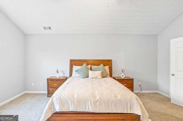 carpeted bedroom featuring a textured ceiling