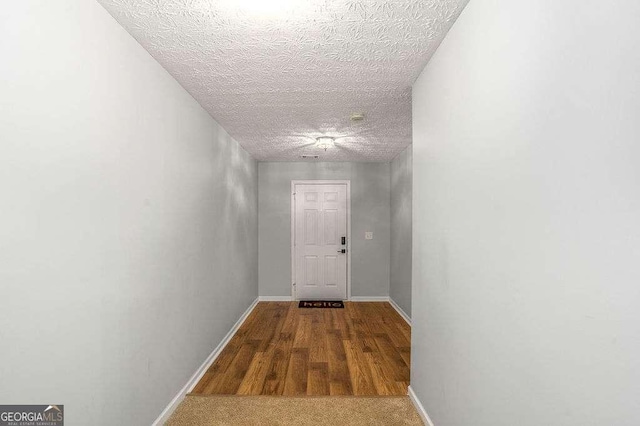 hallway featuring a textured ceiling