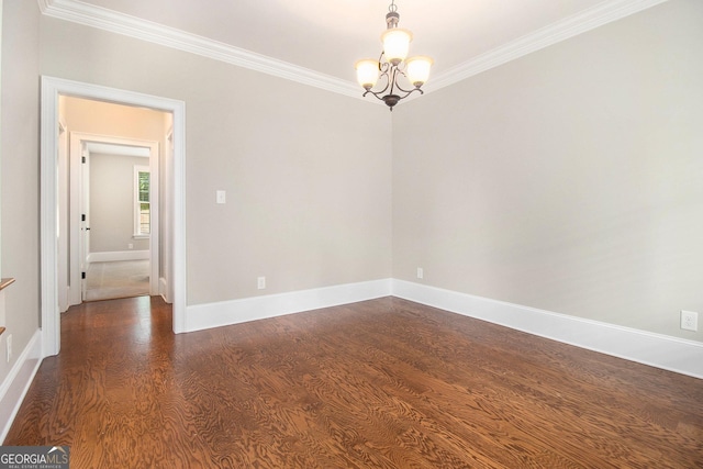 unfurnished room with crown molding, a chandelier, dark wood-type flooring, and baseboards