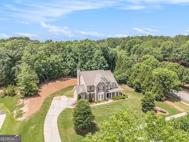 view of subject property with a heavily wooded area