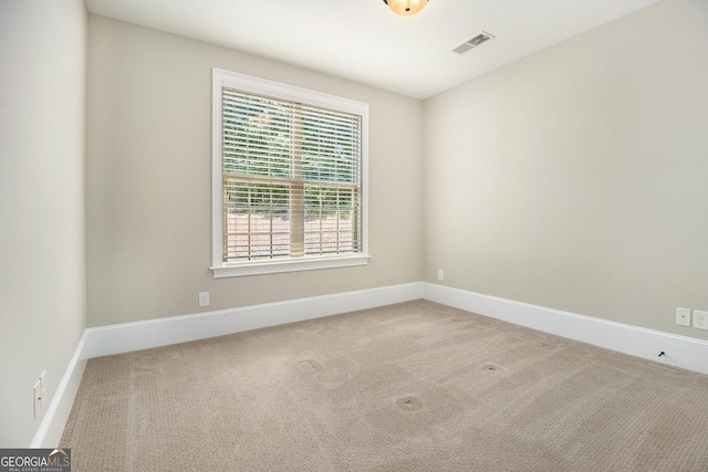 empty room featuring carpet floors and baseboards