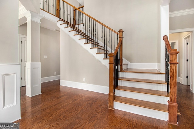 staircase featuring wood finished floors and baseboards