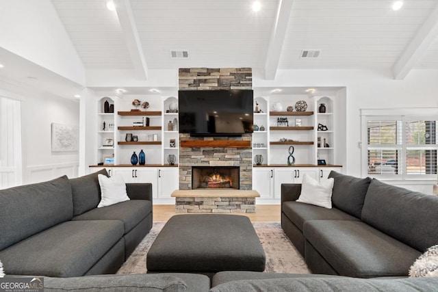 living room featuring a stone fireplace, wood ceiling, lofted ceiling with beams, light wood-type flooring, and built in features