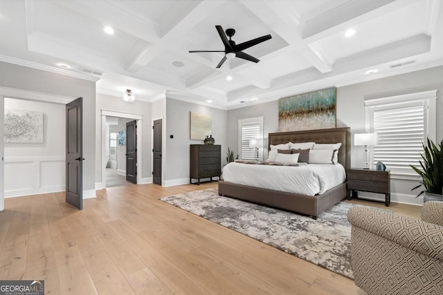 bedroom with coffered ceiling, multiple windows, light hardwood / wood-style floors, and beamed ceiling