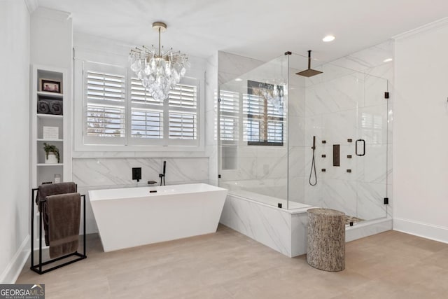 bathroom with separate shower and tub and a notable chandelier