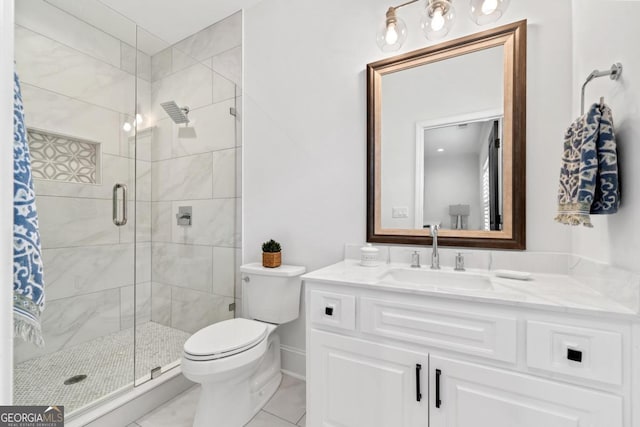 bathroom featuring vanity, toilet, an enclosed shower, and tile patterned flooring