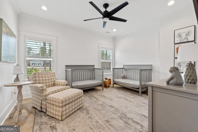 bedroom with crown molding, ceiling fan, and light wood-type flooring