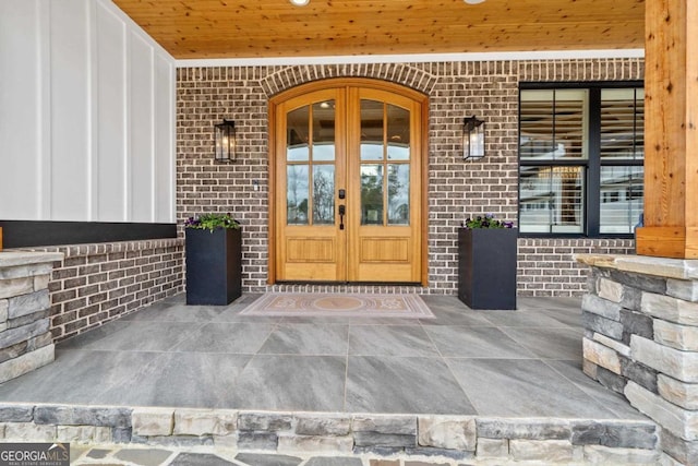 doorway to property featuring french doors and a porch