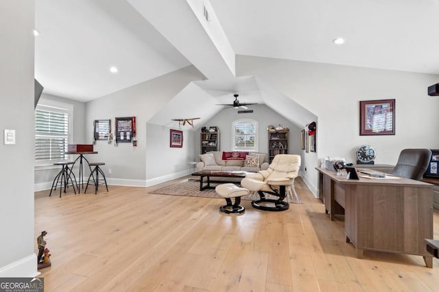 living room with lofted ceiling, ceiling fan, and light hardwood / wood-style flooring