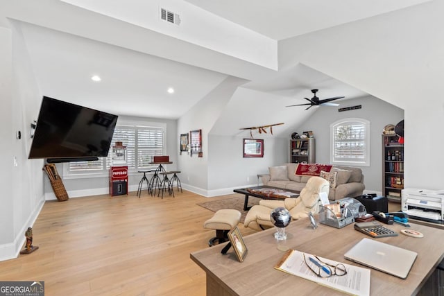 living room with lofted ceiling, ceiling fan, and light wood-type flooring