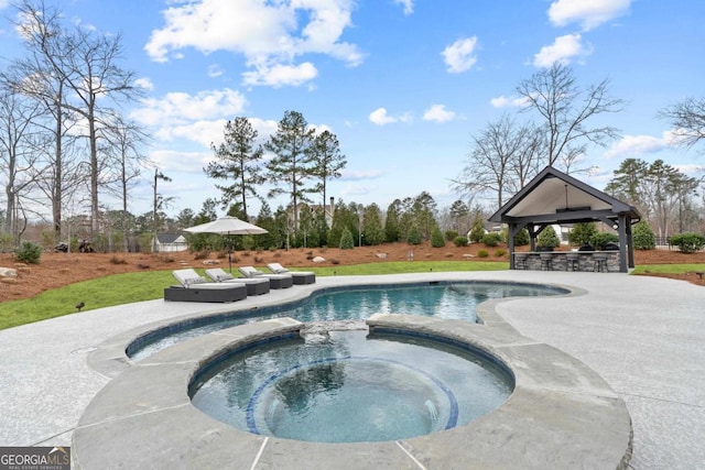 view of pool with a bar, a gazebo, and an in ground hot tub