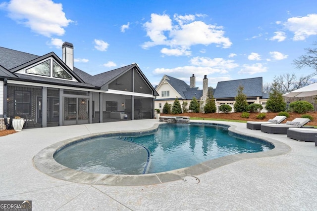 view of pool featuring a patio and a sunroom