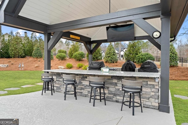 view of patio featuring a grill, a gazebo, and an outdoor bar