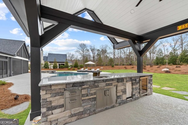 view of patio / terrace featuring area for grilling and sink