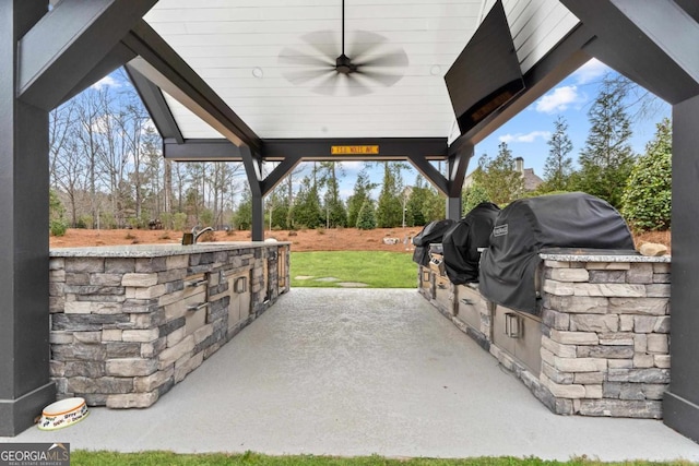 view of patio / terrace with ceiling fan, exterior kitchen, and area for grilling