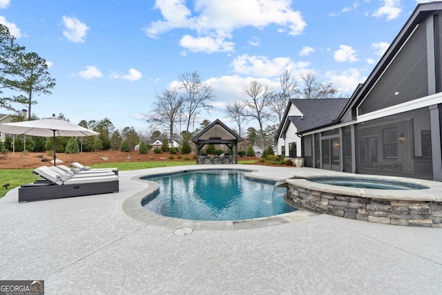 view of swimming pool with an in ground hot tub, a patio area, and a gazebo