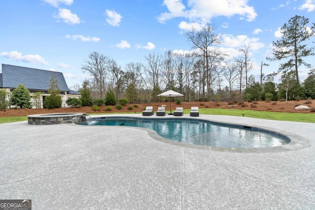 view of pool featuring a patio and an in ground hot tub