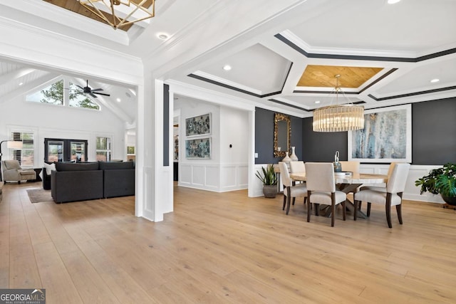 dining space featuring beam ceiling, ornamental molding, coffered ceiling, and light wood-type flooring