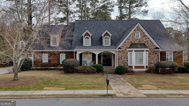 new england style home featuring a front lawn