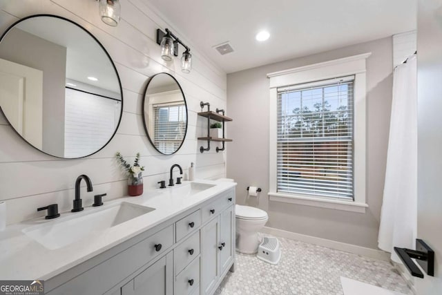 bathroom with vanity, plenty of natural light, decorative backsplash, and toilet