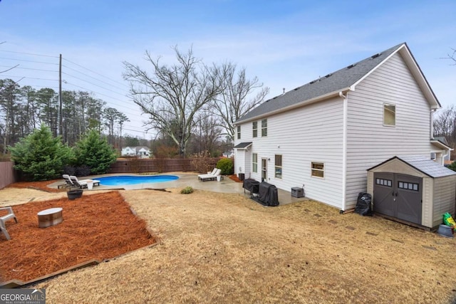 exterior space with a storage unit, a fenced in pool, a patio, and central air condition unit