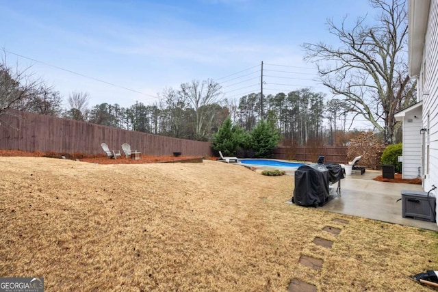 view of yard with a fenced in pool and a patio