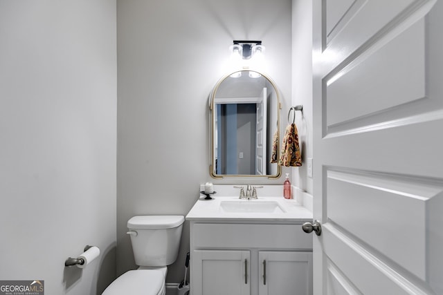 bathroom featuring vanity and toilet