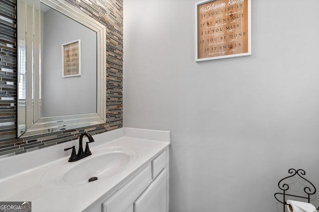 bathroom featuring vanity and decorative backsplash