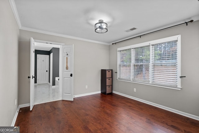 unfurnished bedroom with crown molding, visible vents, baseboards, and wood finished floors