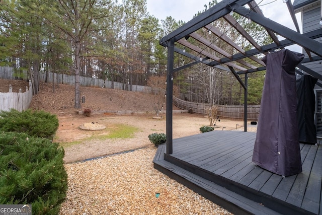 wooden deck featuring a fenced backyard and a pergola