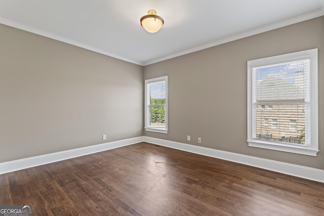 unfurnished room featuring dark wood-type flooring and crown molding