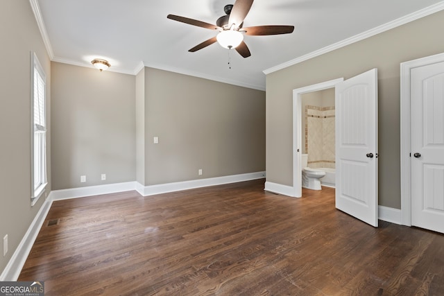 unfurnished bedroom featuring multiple windows, ornamental molding, dark hardwood / wood-style flooring, and ensuite bath