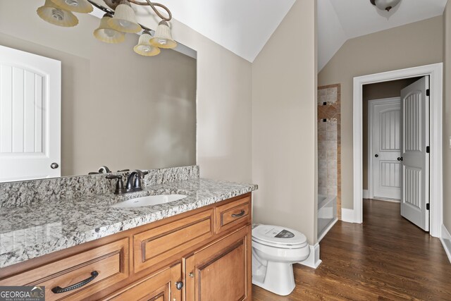 full bathroom featuring vaulted ceiling, shower / washtub combination, wood-type flooring, vanity, and toilet