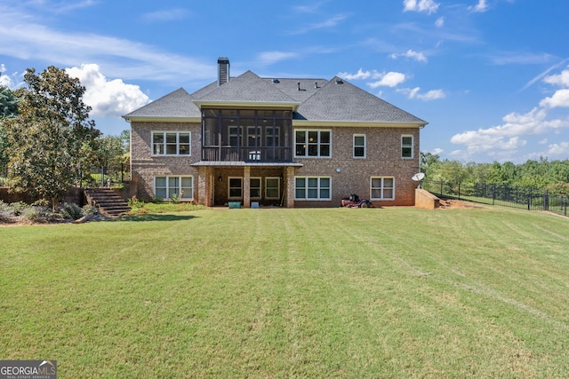 back of property with a sunroom and a lawn