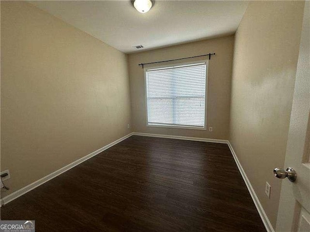 spare room with dark hardwood / wood-style floors