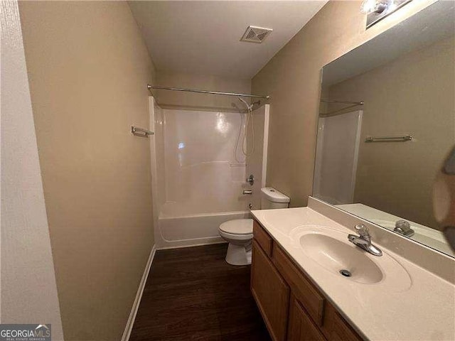 full bathroom featuring washtub / shower combination, vanity, toilet, and hardwood / wood-style floors