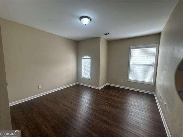 spare room featuring dark hardwood / wood-style floors