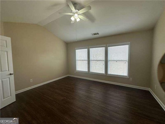 unfurnished room featuring vaulted ceiling, dark hardwood / wood-style floors, and ceiling fan