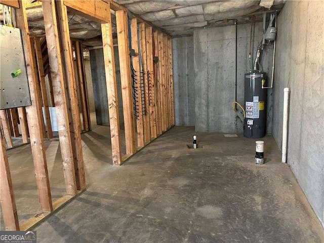 basement featuring gas water heater and electric panel