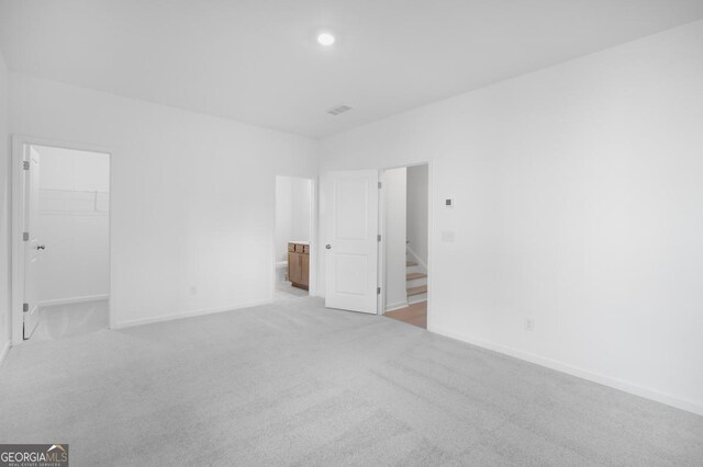 3812 Thatcher Dr SW, Marietta, GA 30008 - unfurnished bedroom featuring recessed lighting, visible vents, a walk in closet, baseboards, and light colored carpet