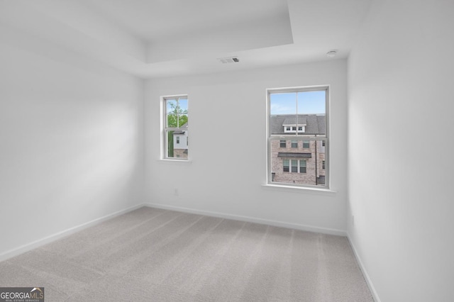 3812 Thatcher Dr SW, Marietta, GA 30008 - carpeted empty room featuring a tray ceiling, visible vents, and baseboards