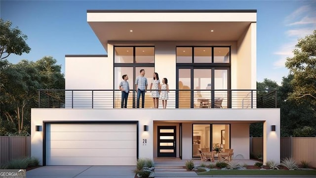 view of front of property featuring a garage and a balcony