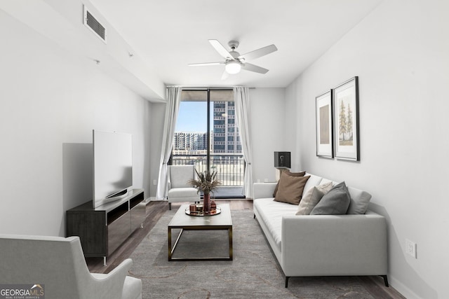 3040 Peachtree Rd NW Unit 613, Atlanta, GA 30305 - living area featuring wood finished floors, a ceiling fan, and expansive windows