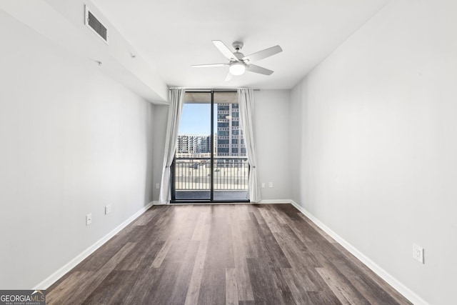 3040 Peachtree Rd NW Unit 613, Atlanta, GA 30305 - unfurnished room with ceiling fan, dark wood-style flooring, and floor to ceiling windows
